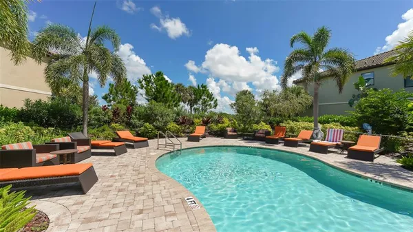 an outdoor space with pool and furniture