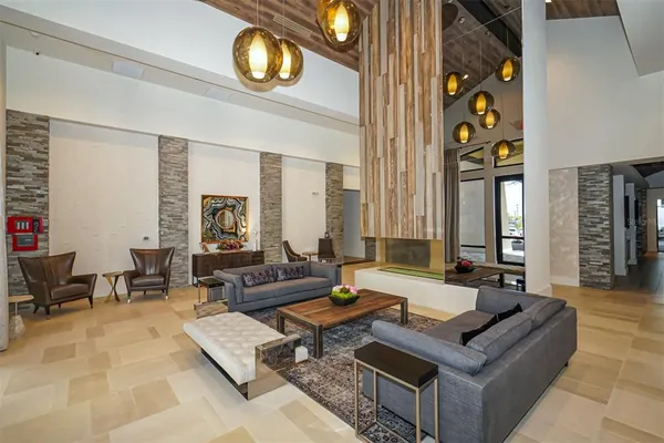 a living room with furniture a table and wooden floor