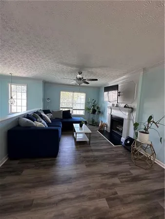 a living room with furniture fireplace and a window