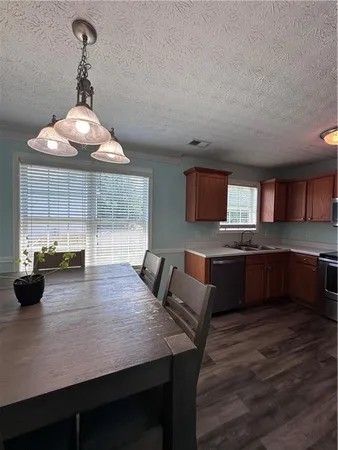 a kitchen with a table chairs and microwave