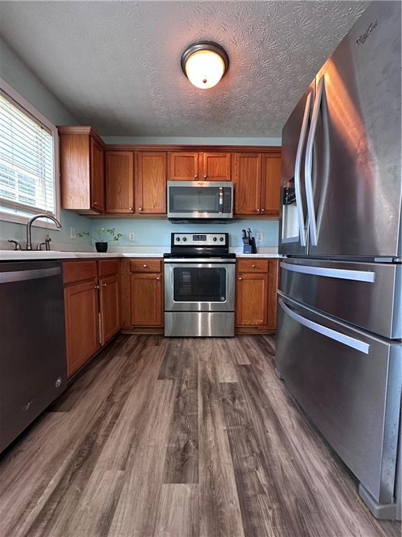 1591 Marceau Drive Conley, GA 30288 - Photo 23 of 47 a kitchen with stainless steel appliances granite countertop a stove and a sink