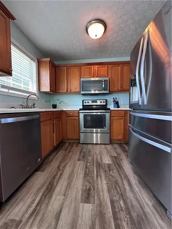 a open kitchen with stainless steel appliances granite countertop a stove sink and cabinets