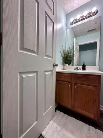 a bathroom with a double vanity sink and a mirror