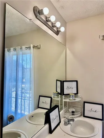 a bathroom with a toilet sink and mirror