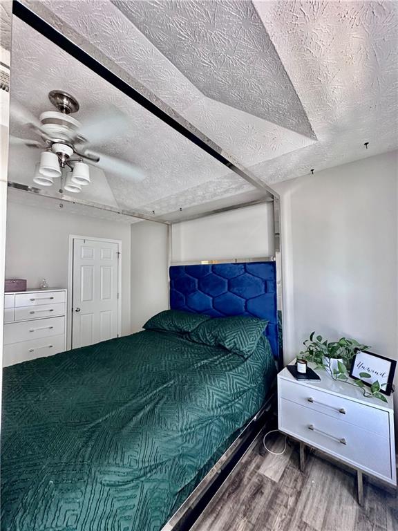 1591 Marceau Drive Conley, GA 30288 - Photo 33 of 47 a bedroom with a large bed and a chandelier