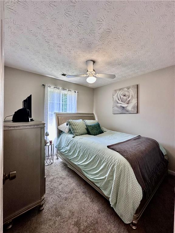 1591 Marceau Drive Conley, GA 30288 - Photo 34 of 47 a bedroom with a bed and a chandelier