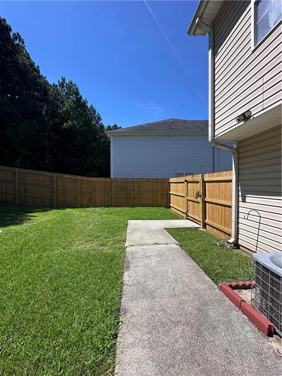 1591 Marceau Drive Conley, GA 30288 - Photo 42 of 47 a view of yard with swimming pool and wooden fence