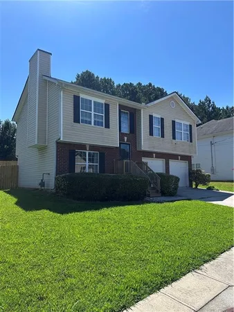 a front view of a house with a yard
