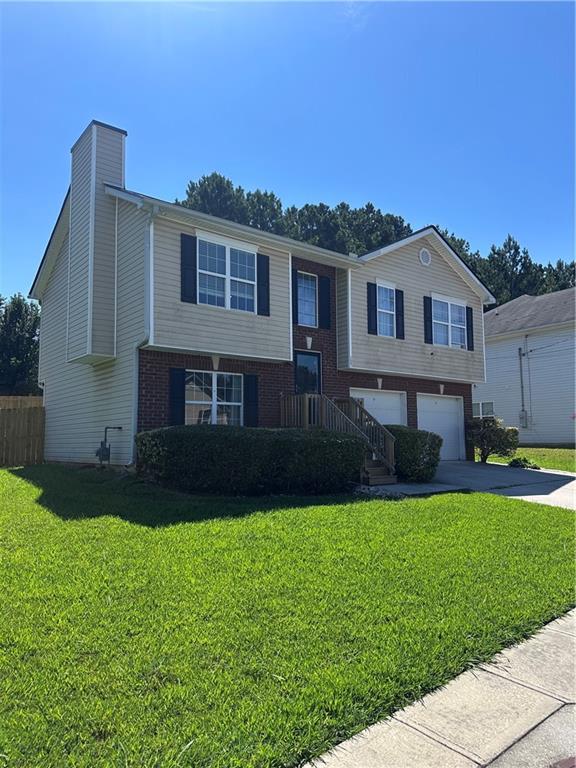 1591 Marceau Drive Conley, GA 30288 - Photo 5 of 47 a front view of a house with a yard