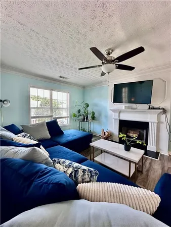 a living room with furniture and a fireplace