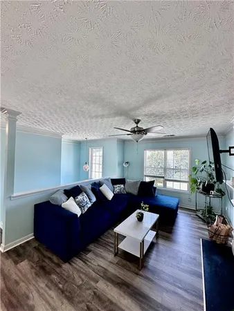 a living room with furniture or couch and a wooden floor
