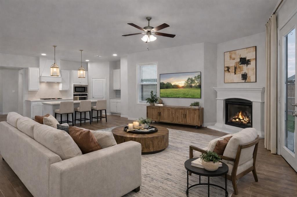 3106 Maverick Drive Forney, TX 75126 - Photo 6 of 32 a living room with furniture kitchen view and a fireplace