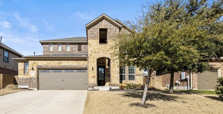 a front view of a house with a yard and garage