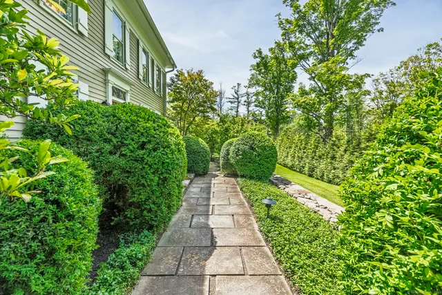 a view of a pathway both side of the house