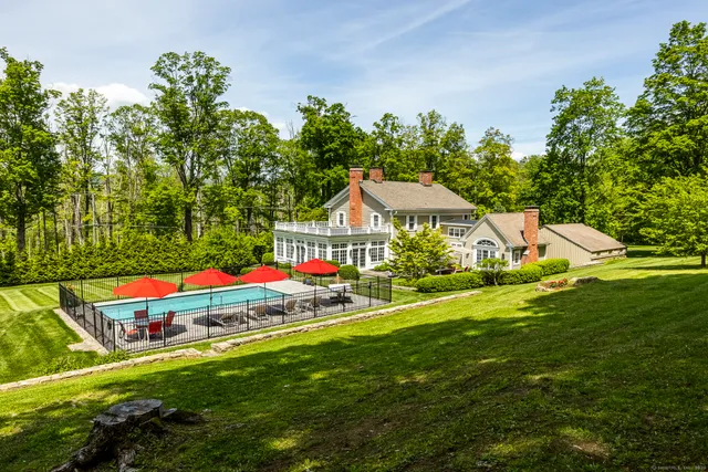 a aerial view of a house with swimming pool garden and patio
