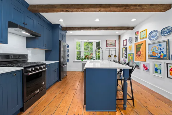 a kitchen with stainless steel appliances granite countertop a stove and a refrigerator