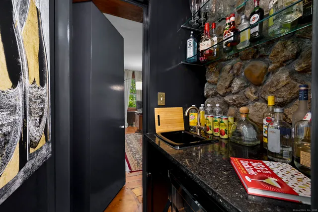 a bathroom with mirror and sink