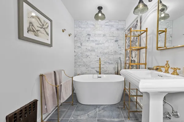 a white bath tub sitting next to a white sink