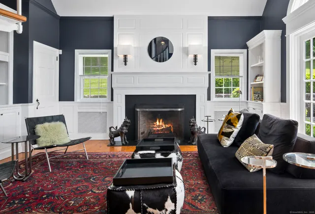 a living room with furniture fireplace and window