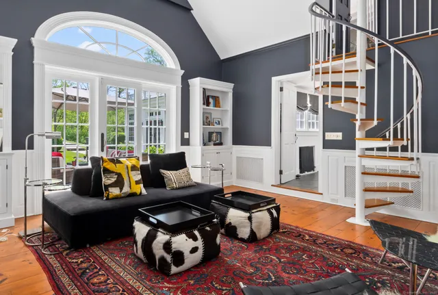 a living room with furniture and large windows