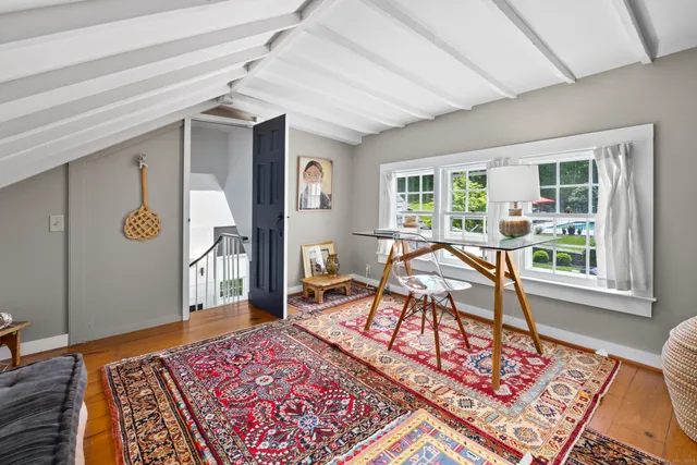 a living room with a rug and a table
