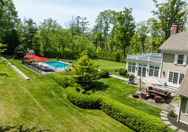 a view of yard with swimming pool and green space