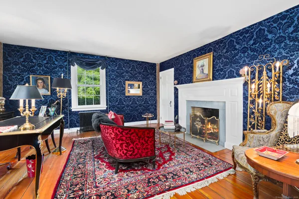 a living room with furniture rug and a fireplace