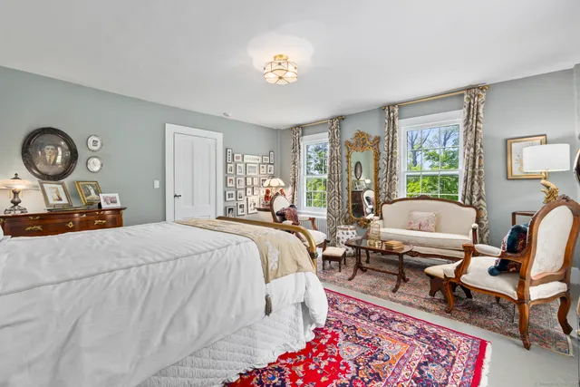 a bedroom with a bed a table and chair