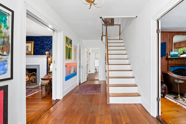 a view of entryway and hall with wooden floor