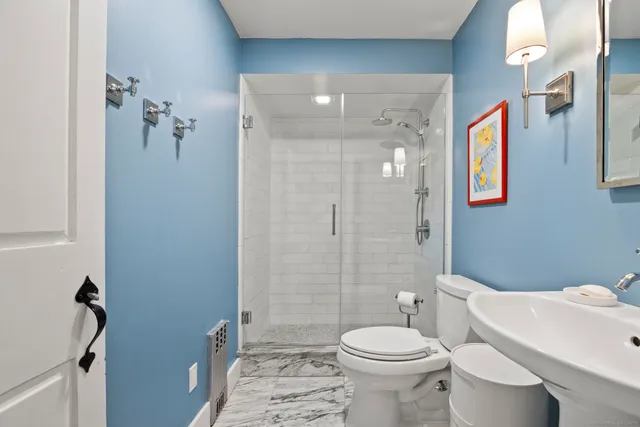 a bathroom with a toilet sink and shower