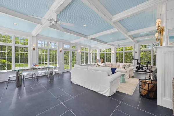 a living room with furniture and large windows