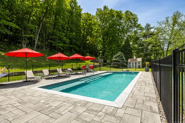 a view of swimming pool with sitting area and furniture