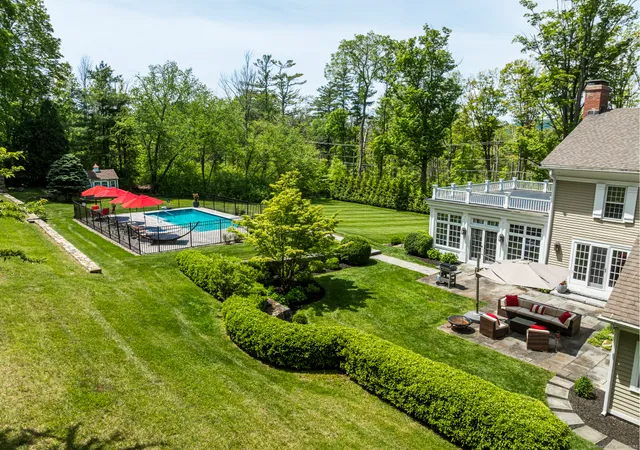 a view of yard with swimming pool and green space