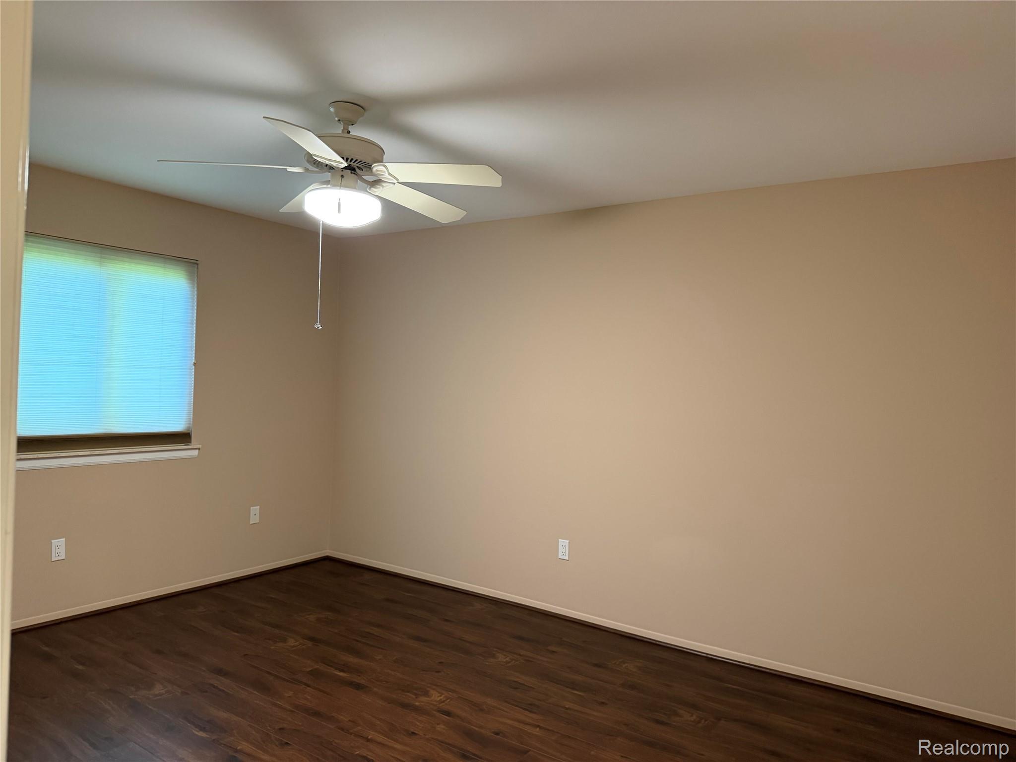 5220 West Utica Road Utica, MI 48317 - Photo 15 of 24 Neutral tone walls with dark wood-finish flooring
