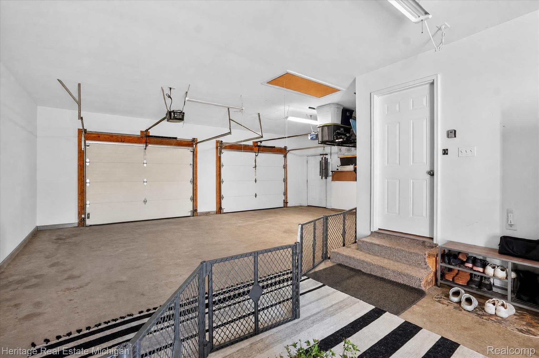 7225 Baldwin Road Swartz Creek, MI 48473 - Photo 41 of 44 Spacious garage featuring two overhead doors, a concrete floor, and an interior access door