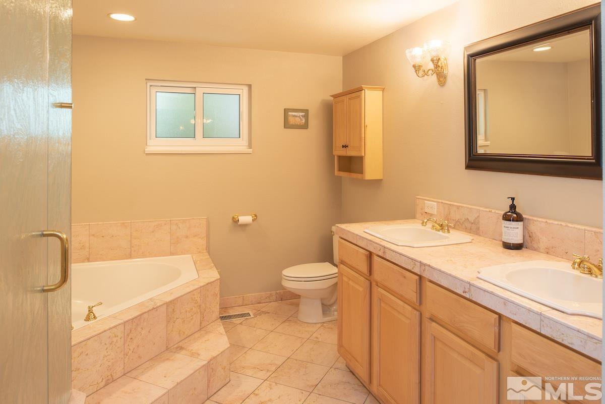 2000 Dant Boulevard Reno, NV 89509 - Photo 12 of 40 a bathroom with a granite countertop sink toilet and shower