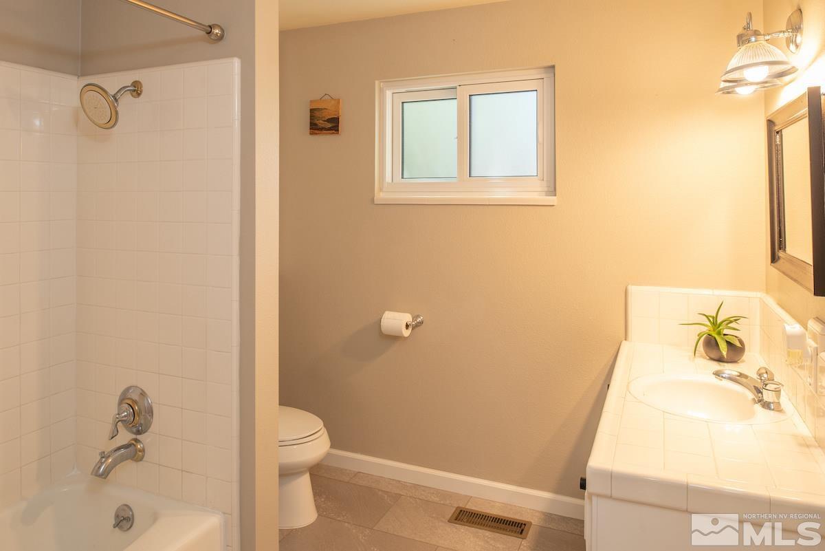 2000 Dant Boulevard Reno, NV 89509 - Photo 16 of 40 a bathroom with a granite countertop sink toilet and shower