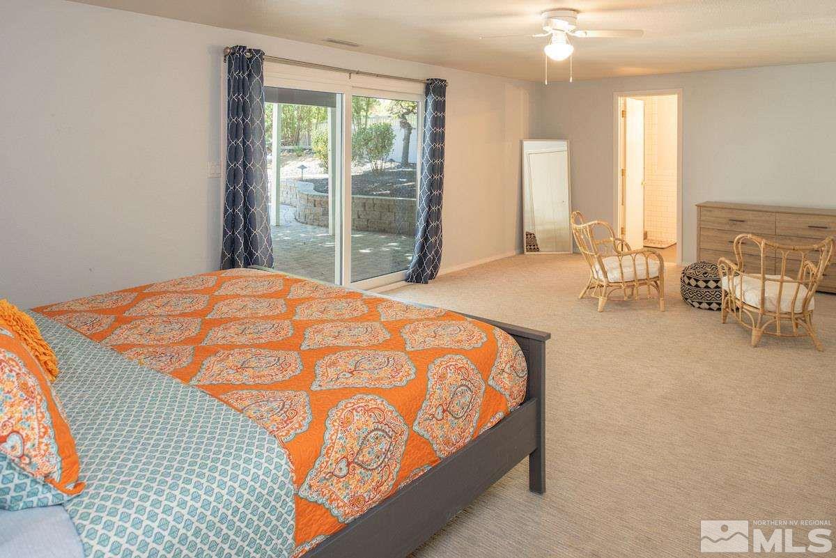 2000 Dant Boulevard Reno, NV 89509 - Photo 18 of 40 a bed sitting in a spacious bedroom next to a window