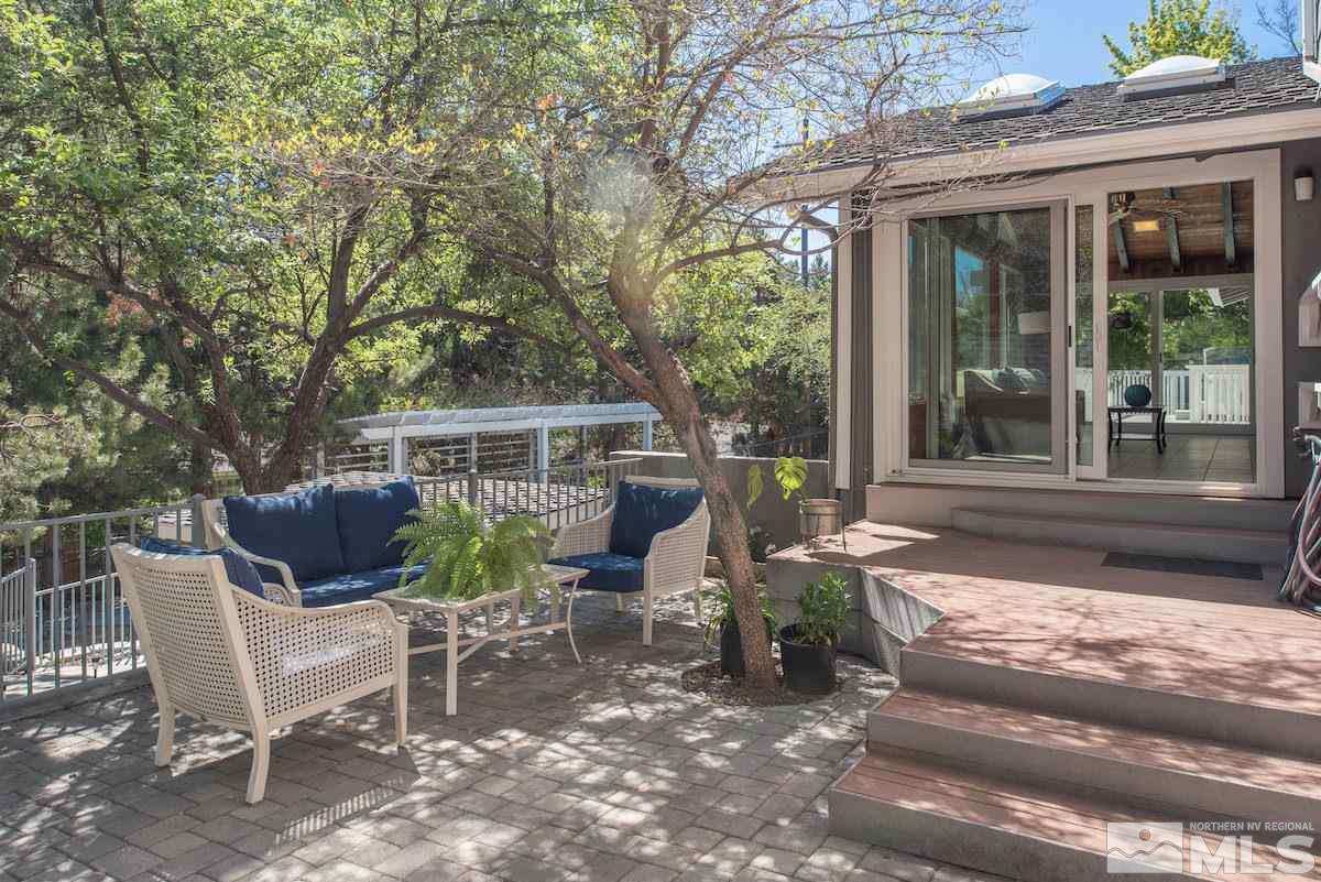 2000 Dant Boulevard Reno, NV 89509 - Photo 31 of 40 a view of a patio with table and chairs potted plants and large tree