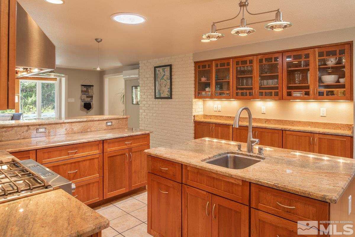 2000 Dant Boulevard Reno, NV 89509 - Photo 6 of 40 a kitchen with stainless steel appliances granite countertop a sink and a counter space