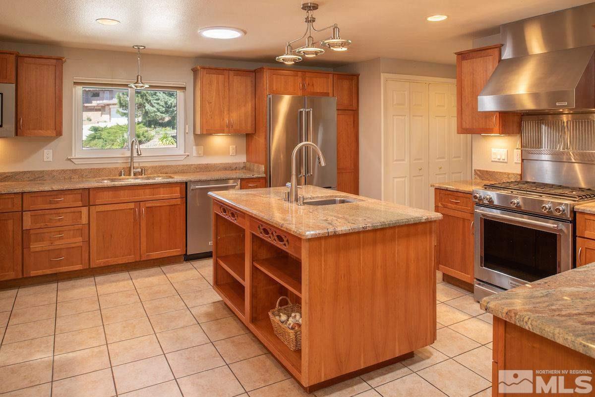2000 Dant Boulevard Reno, NV 89509 - Photo 7 of 40 a kitchen with a stove sink and cabinets
