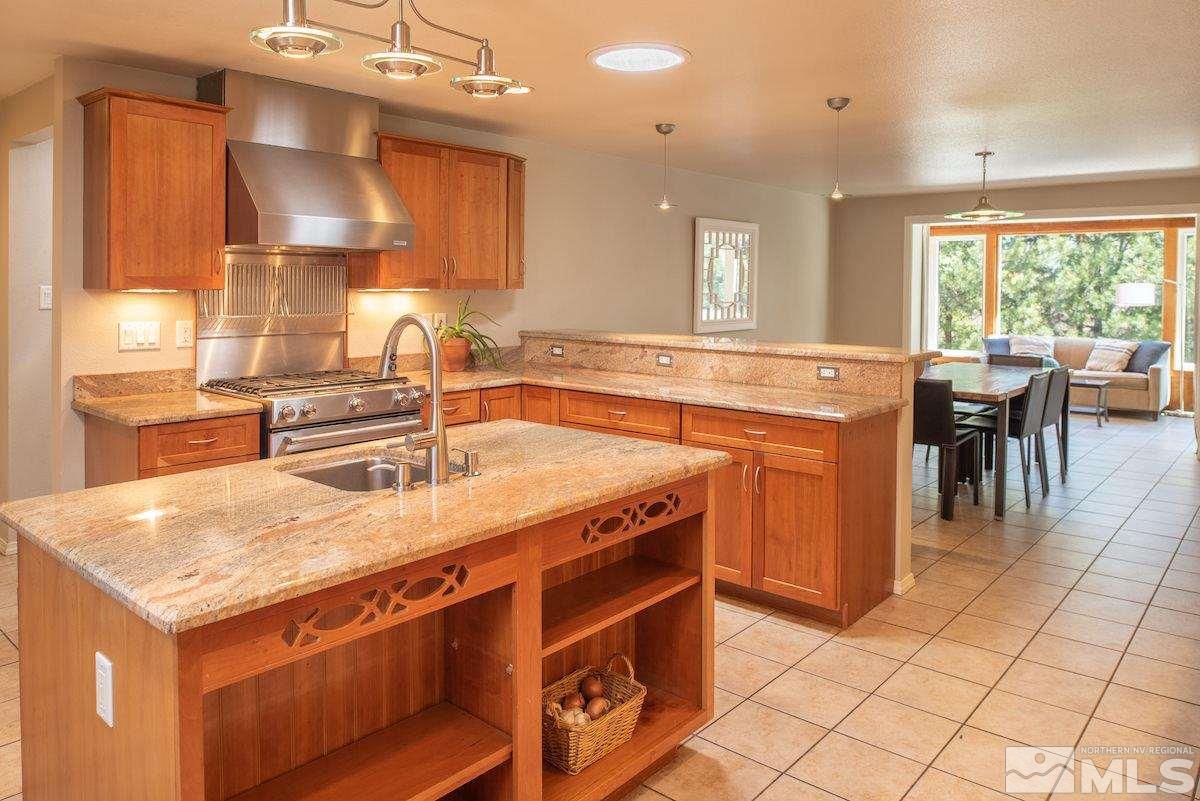 2000 Dant Boulevard Reno, NV 89509 - Photo 8 of 40 a kitchen with a sink a stove a table and chairs