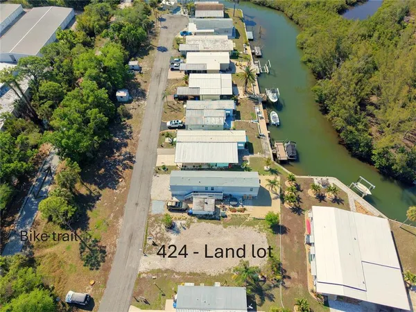 an aerial view of a multi story residential apartment building with a yard