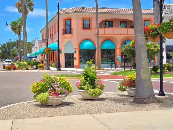 a view of a street with potted plants