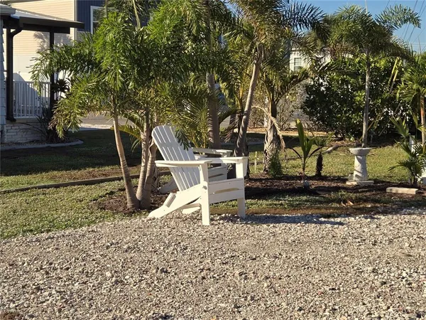 a view of a yard with wooden fence