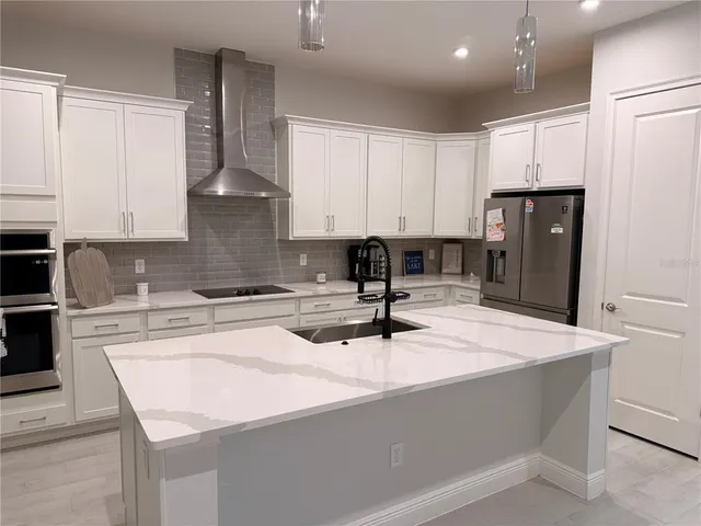 a kitchen with a sink cabinets and appliances