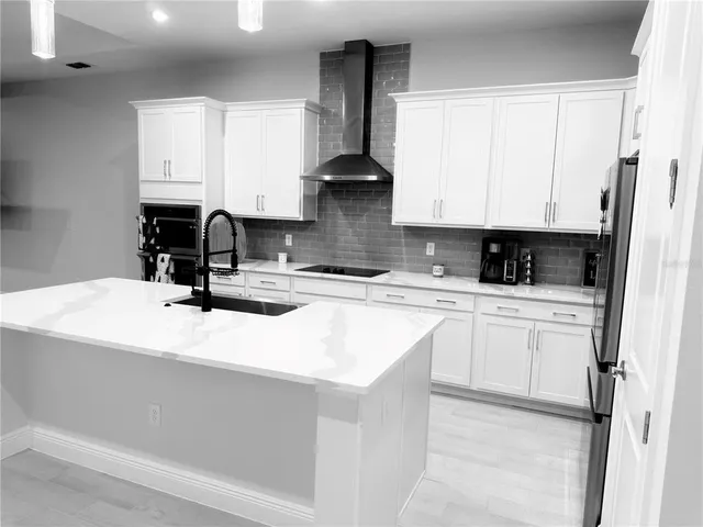 a kitchen with stainless steel appliances granite countertop a sink a stove and microwave