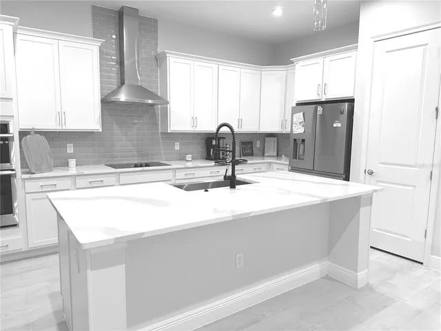 a kitchen with granite countertop a sink and a stove