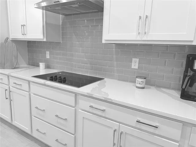 a kitchen with white cabinets and a sink