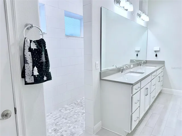 a bathroom with a sink vanity and a mirror
